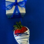 White chocolate covered strawberry drizzled with blue topping