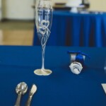 Champagne glass on top of blue table cloth